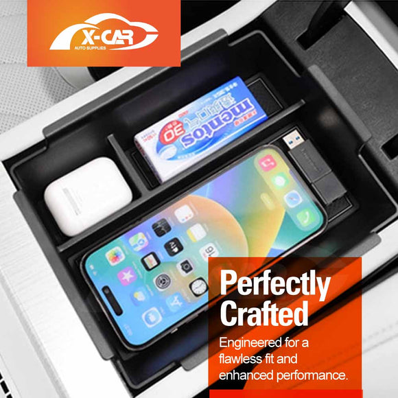 X-CAR Car console organiser with phone, air freshener, and wireless earbuds stored. 